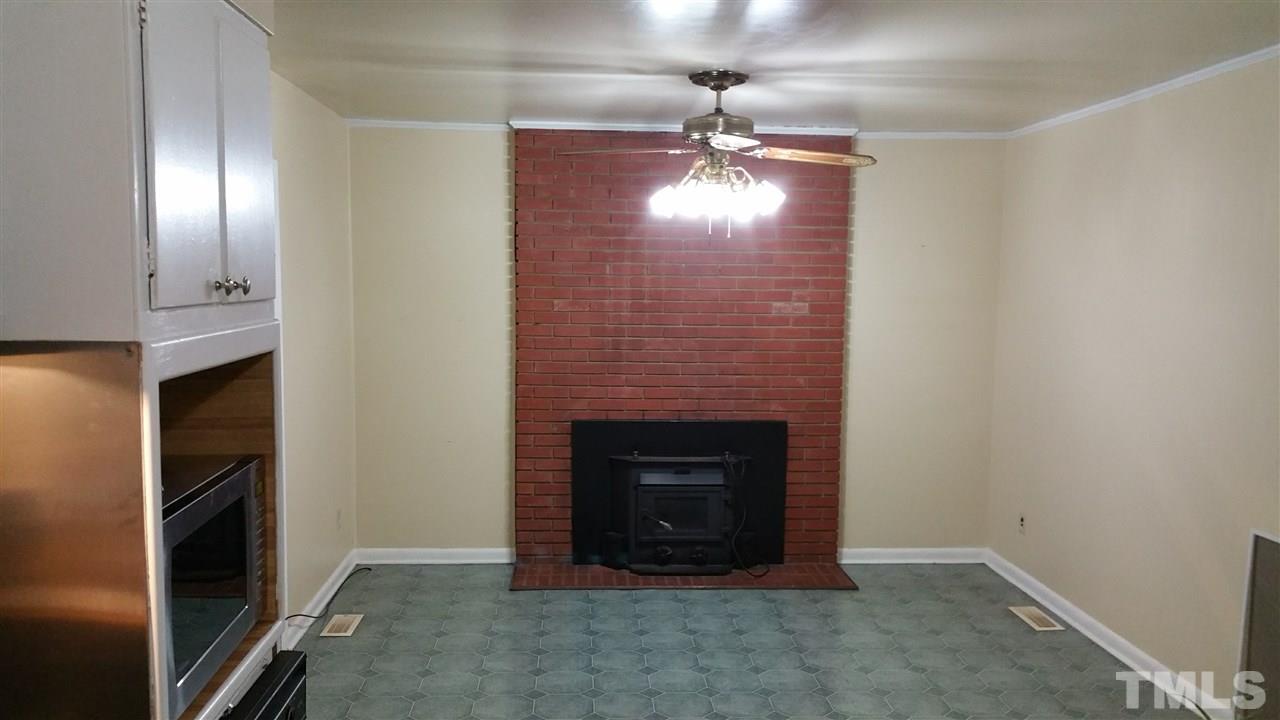 716 Cooper Road Raleigh, NC 27610 - Photo 5 of 25 an empty room with a fireplace