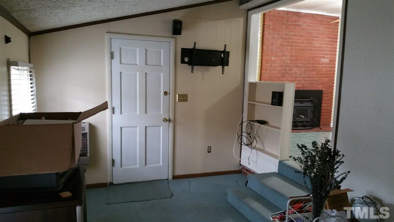 716 Cooper Road Raleigh, NC 27610 - Photo 7 of 25 a view of a hallway with wooden floor and front door