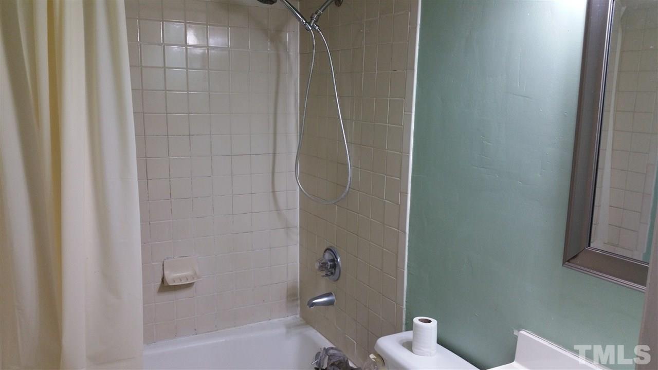 716 Cooper Road Raleigh, NC 27610 - Photo 10 of 25 a bathroom with a shower and toilet