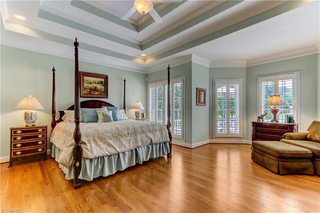 5501 Gray Leigh Drive Oak Ridge, NC 27310 - Photo 12 of 30 The Master Bedroom has a triple tray ceiling, recessed lighting, ceiling fan with light, and over-sized windows with Plantation Shutters.