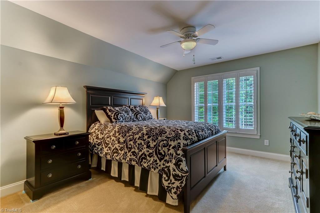 5501 Gray Leigh Drive Oak Ridge, NC 27310 - Photo 16 of 30 Bedroom 2 with private bath. Wall to wall carpeting, Plantation Shutters, Ceiling fan with light. Large walk-in closet.