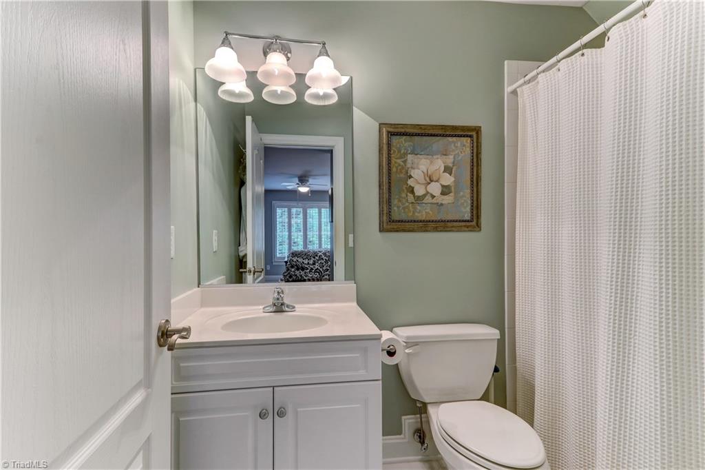 5501 Gray Leigh Drive Oak Ridge, NC 27310 - Photo 17 of 30 Private full bath for Bedroom 2 has tile floor, ceramic tub with tile surround.