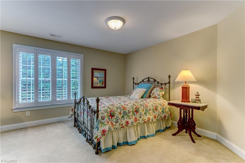 5501 Gray Leigh Drive Oak Ridge, NC 27310 - Photo 18 of 30 Bedroom 3. Wall to wall carpeting, Plantation Shutters, Ceiling fixture, and large closet.