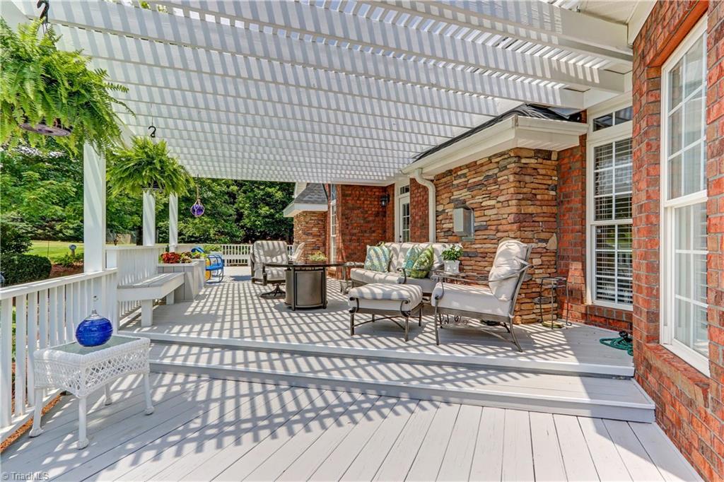 5501 Gray Leigh Drive Oak Ridge, NC 27310 - Photo 26 of 30 The Pergola creates a cozy sitting area. More built in benches and planters.