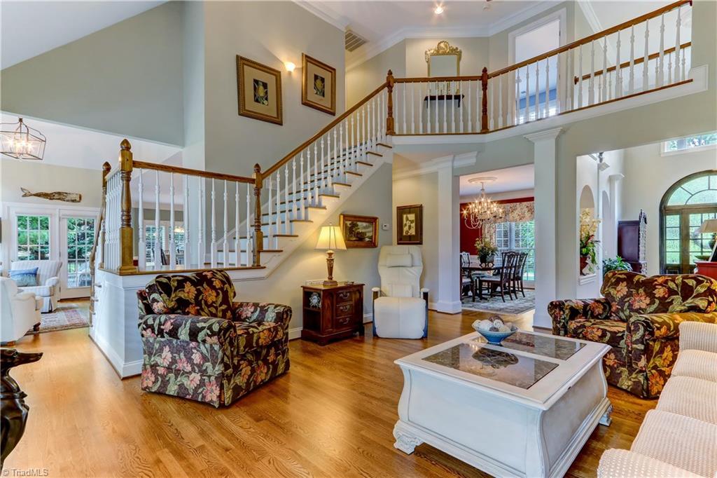 5501 Gray Leigh Drive Oak Ridge, NC 27310 - Photo 7 of 30 Another view of the Great Room shows 2nd staircase making the 2nd floor easily accessible from any area of the home. Sconce lighting accent on stair wall.