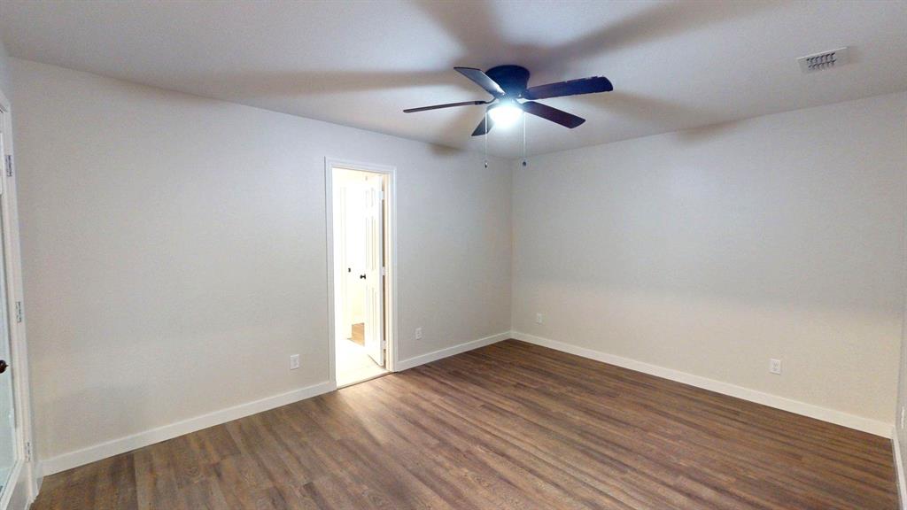 1110 Mill Run Road Athens, TX 75751 - Photo 16 of 24 an empty room with wooden floor and windows