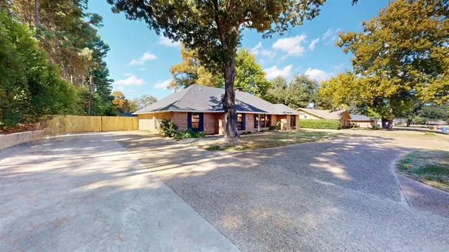 a front view of a house with yard and green space