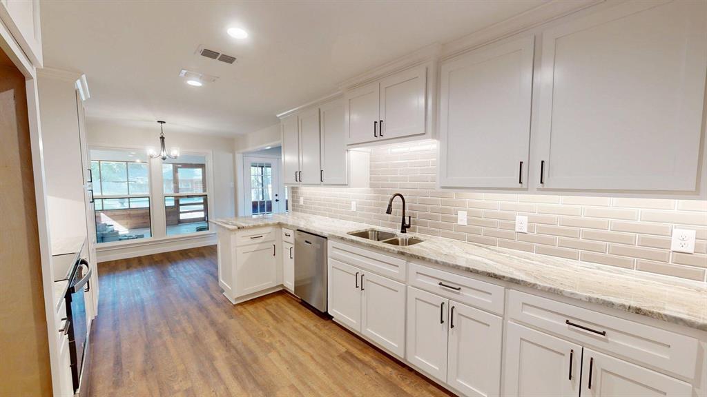 1110 Mill Run Road Athens, TX 75751 - Photo 7 of 24 a kitchen with sink cabinets and wooden floor