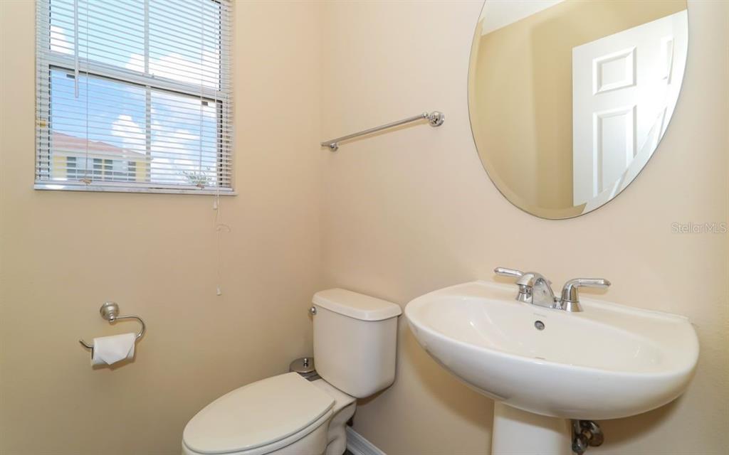 7339 Black Walnut Way Lakewood Ranch, FL 34202 - Photo 7 of 27 a bathroom with a sink a mirror and a toilet