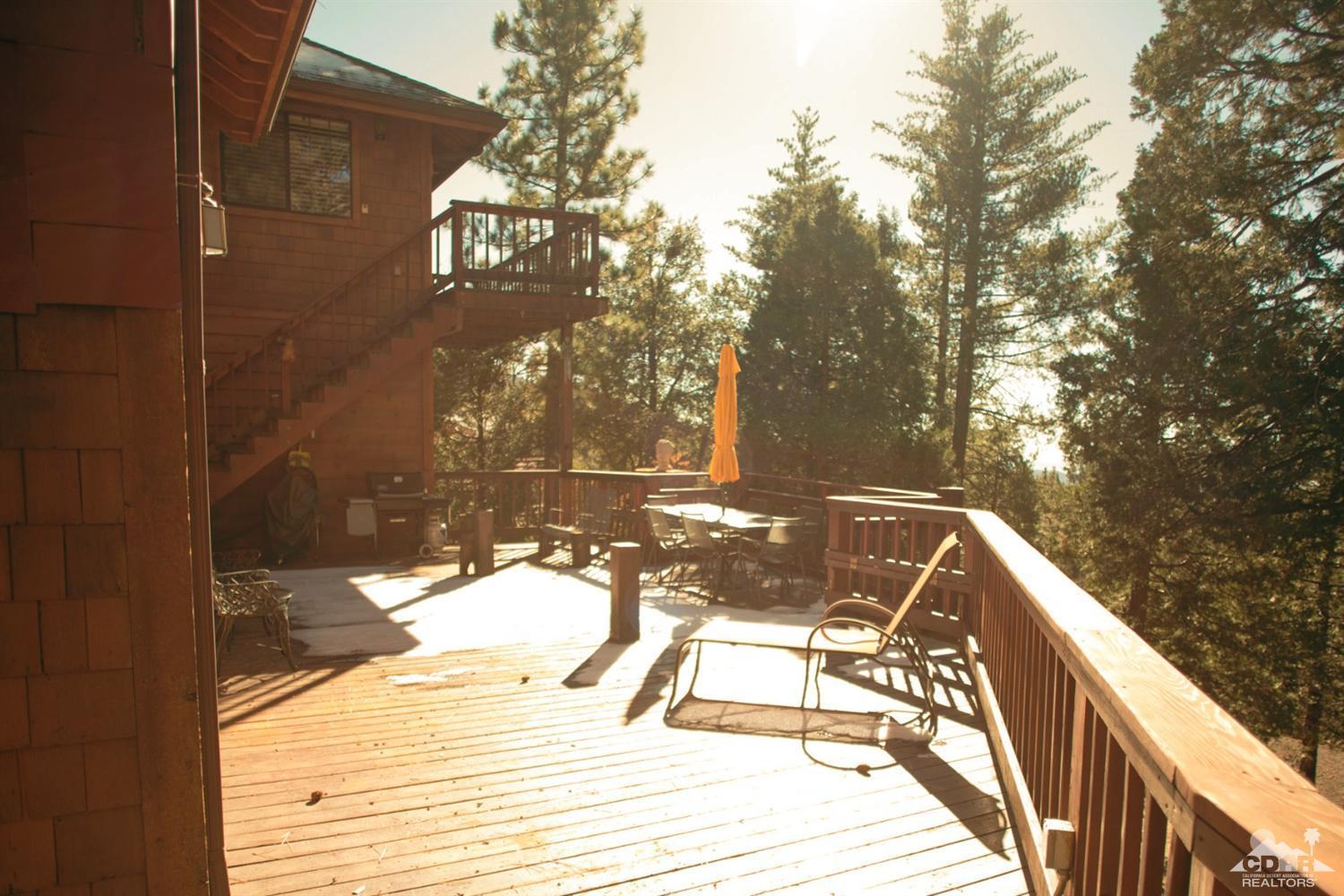 25037 Cougar Road Idyllwild, CA 92549 - Photo 33 of 73 a view of a balcony with a floor to ceiling window with tree