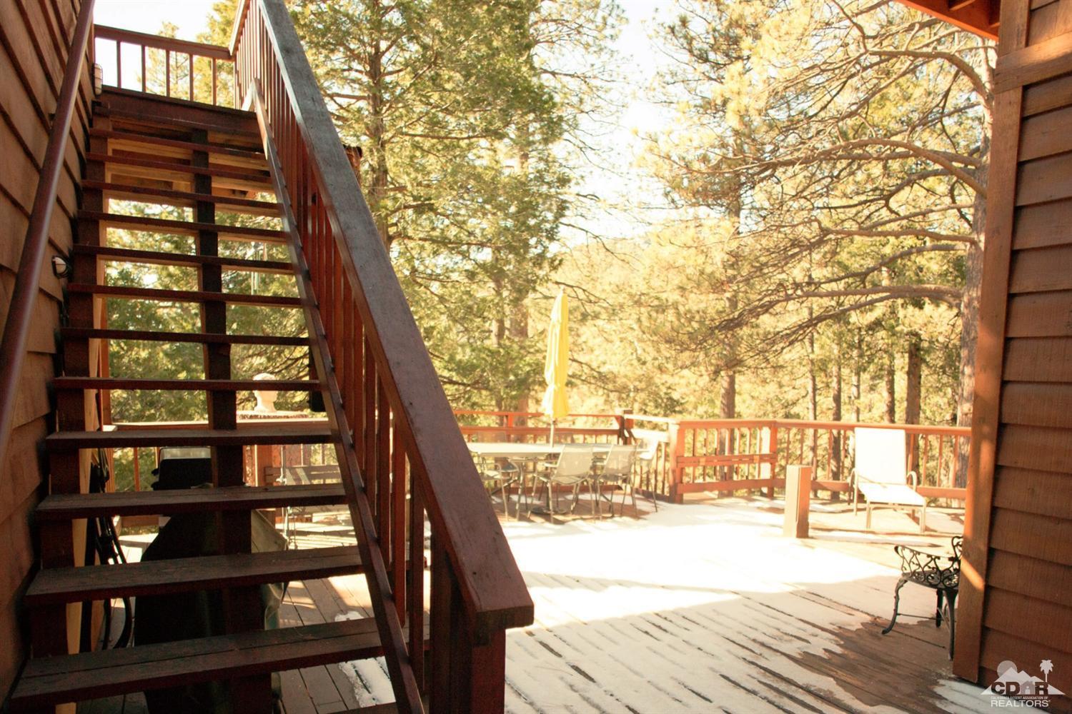 25037 Cougar Road Idyllwild, CA 92549 - Photo 42 of 73 a view of a balcony with wooden floor and fence