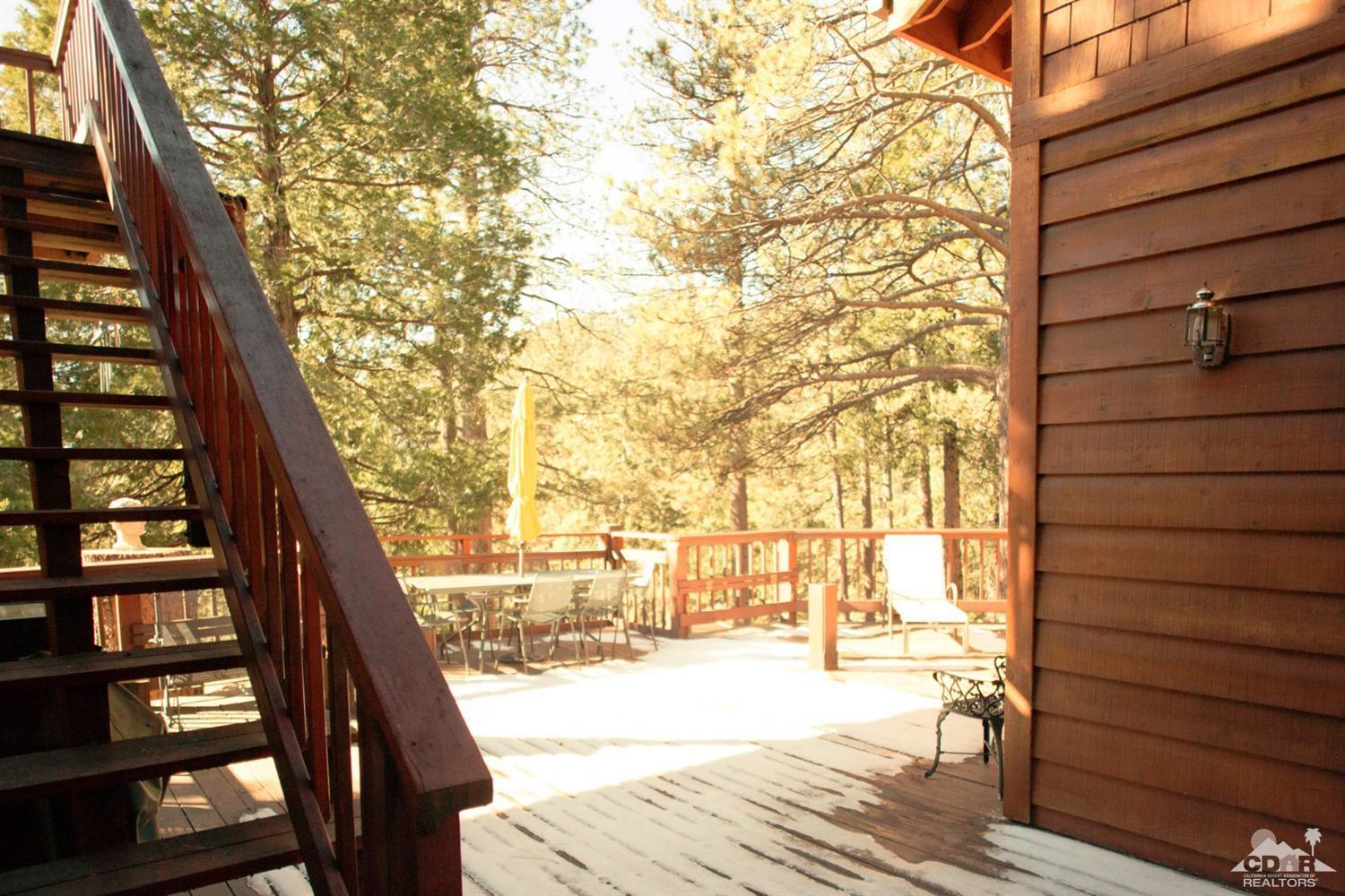 25037 Cougar Road Idyllwild, CA 92549 - Photo 43 of 73 a view of a balcony with wooden floor and iron fence