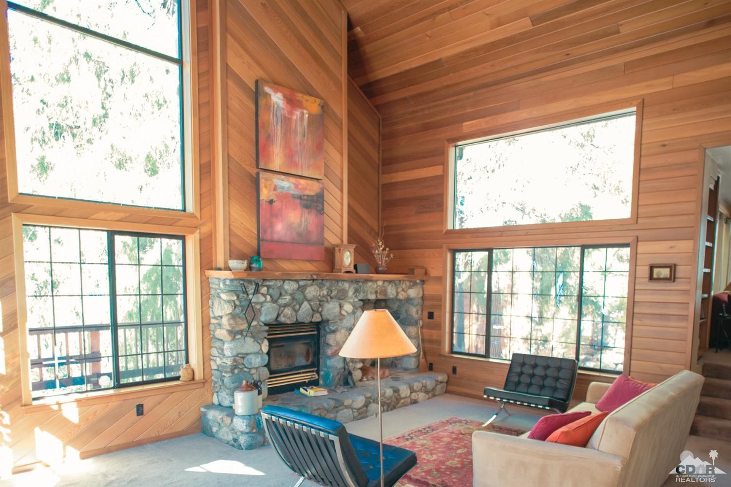25037 Cougar Road Idyllwild, CA 92549 - Photo 67 of 73 a living room with furniture a fireplace and a large window