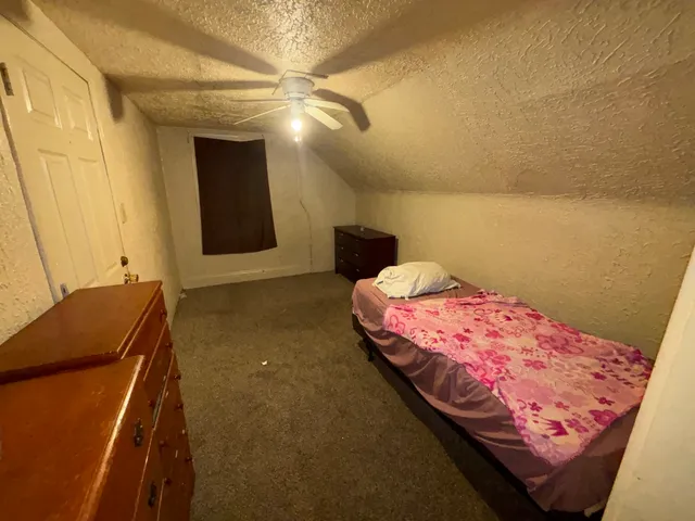 a bedroom with a bed and a mirror