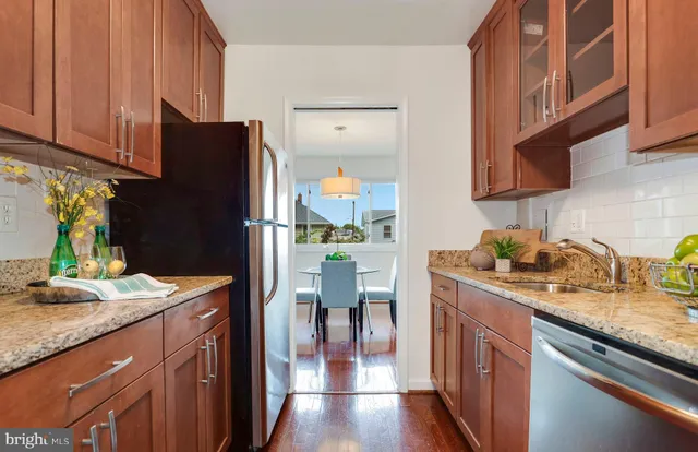 a kitchen with granite countertop stainless steel appliances and wooden cabinets