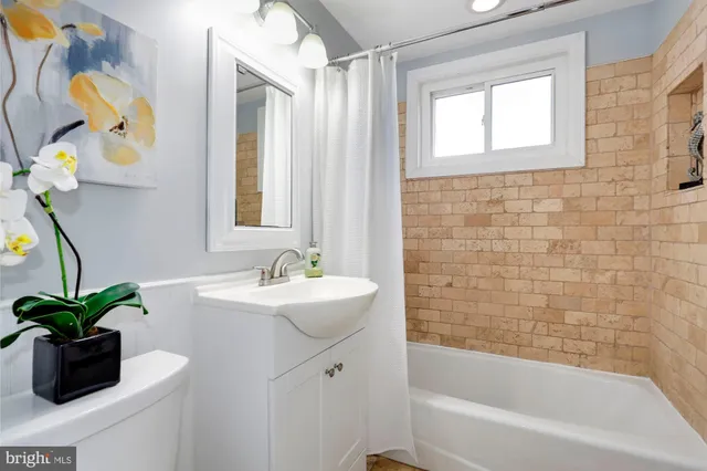 a white bath tub with a shower