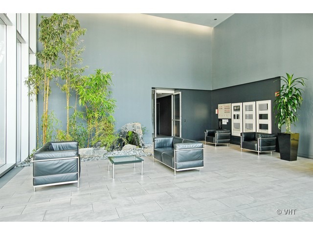 235 West Van Buren Street, Unit 3518 Chicago, IL 60607 - Photo 2 of 9 a living room with furniture and a potted plant