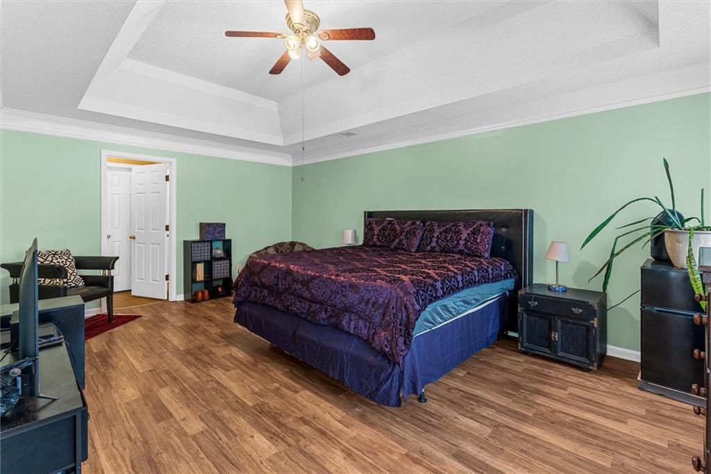 3234 Mineral Ridge Lane Stone Mountain, GA 30087 - Photo 26 of 55 a bedroom with a bed and wooden floor
