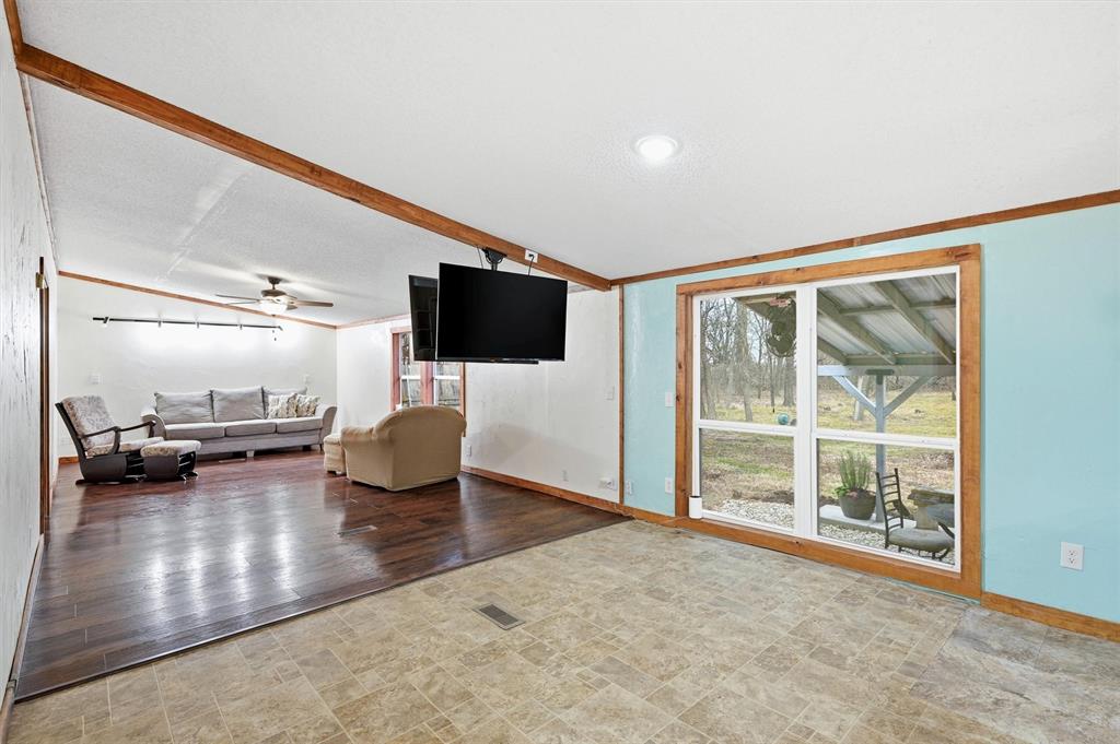 2421 Edwards Road Van Alstyne, TX 75495 - Photo 14 of 40 a view of a livingroom with furniture and a flat screen tv
