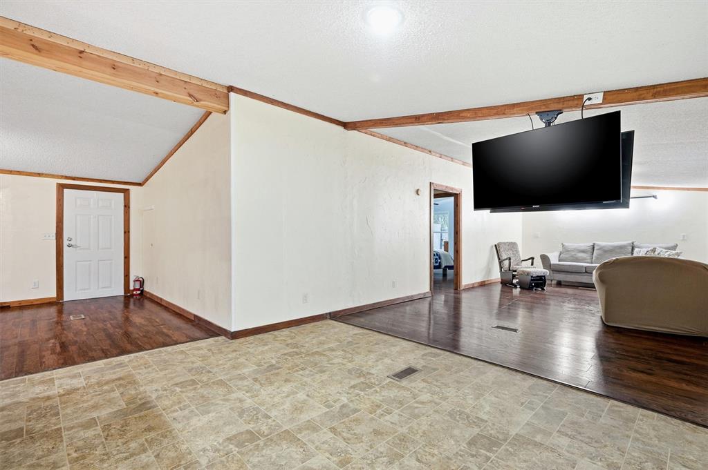 2421 Edwards Road Van Alstyne, TX 75495 - Photo 15 of 40 a living room with furniture and a flat screen tv