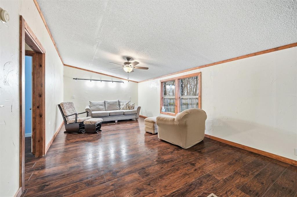 2421 Edwards Road Van Alstyne, TX 75495 - Photo 16 of 40 a living room with furniture and a wooden floor