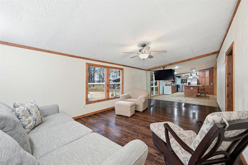 2421 Edwards Road Van Alstyne, TX 75495 - Photo 18 of 40 a living room with furniture and wooden floor