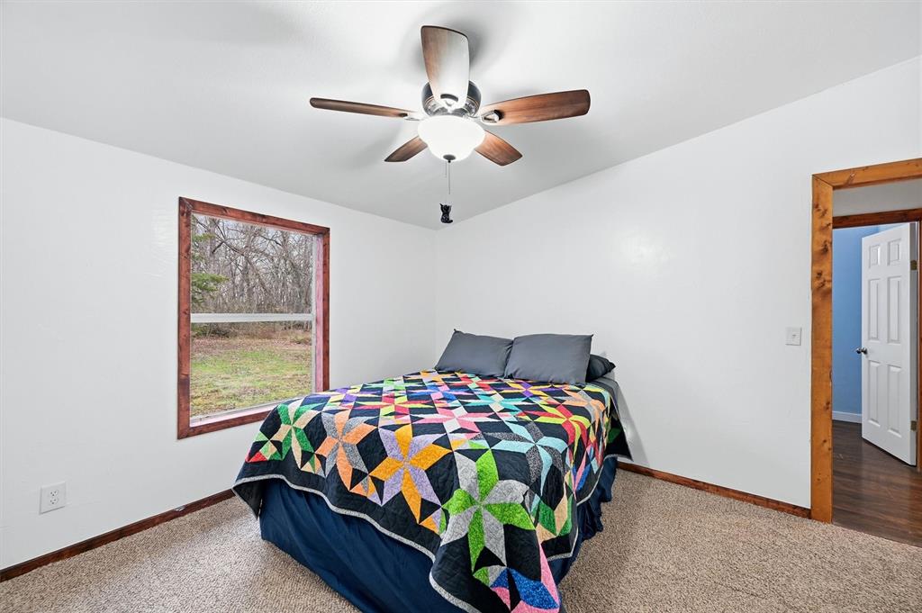 2421 Edwards Road Van Alstyne, TX 75495 - Photo 20 of 40 a bedroom with a bed and window