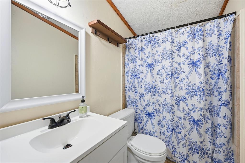 2421 Edwards Road Van Alstyne, TX 75495 - Photo 21 of 40 a bathroom with a sink and a mirror