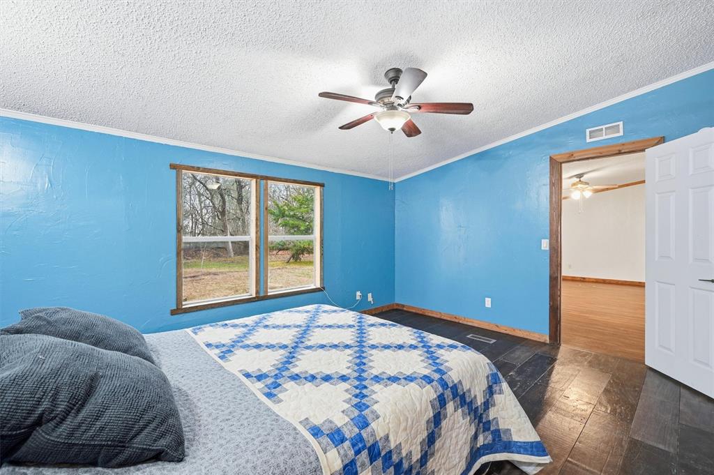 2421 Edwards Road Van Alstyne, TX 75495 - Photo 25 of 40 a bedroom with a bed and a window