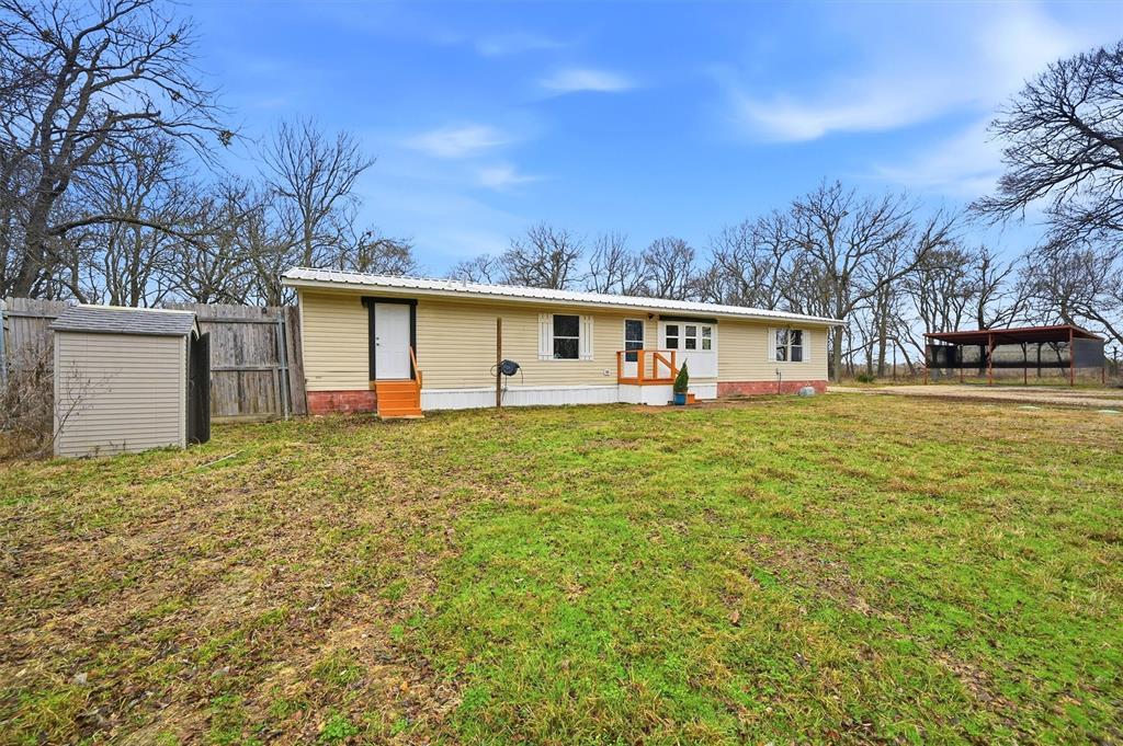 2421 Edwards Road Van Alstyne, TX 75495 - Photo 4 of 40 a front view of house with yard and trees in the background