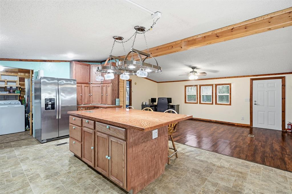 2421 Edwards Road Van Alstyne, TX 75495 - Photo 9 of 40 a large kitchen with kitchen island a stove a sink dishwasher and a dining table
