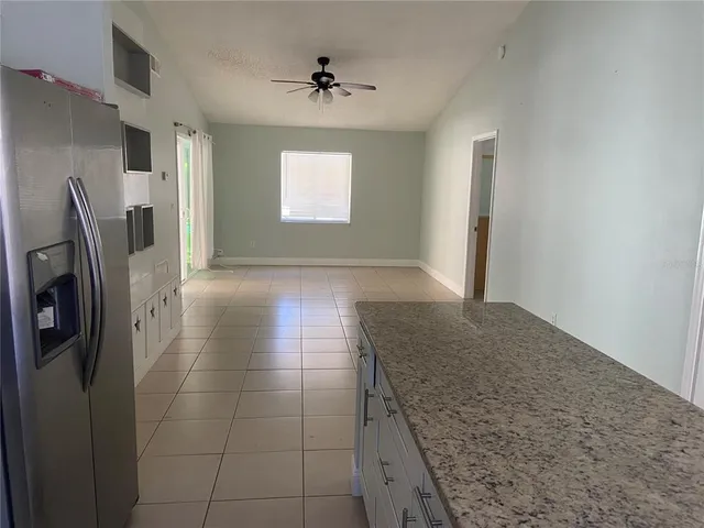 a view of a kitchen with furniture and an empty room