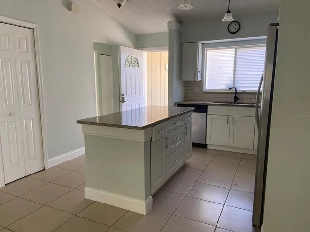 a kitchen with stainless steel appliances granite countertop a sink and a cabinets