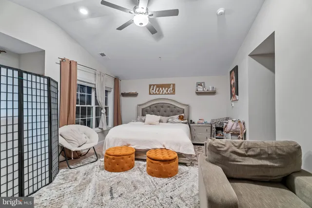 a living room with furniture and a painting on the wall