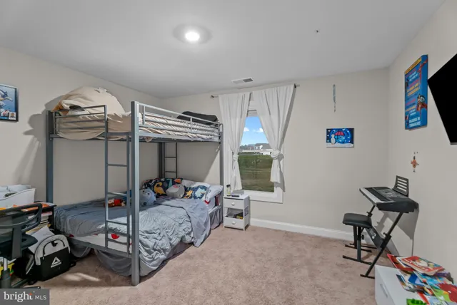 a bedroom with furniture and a window