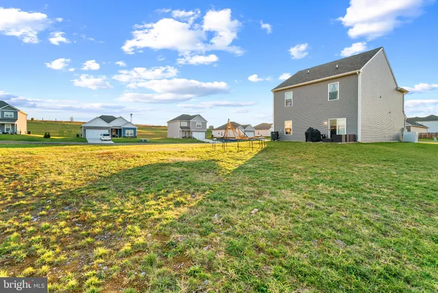 a view of an house with backyard and patio