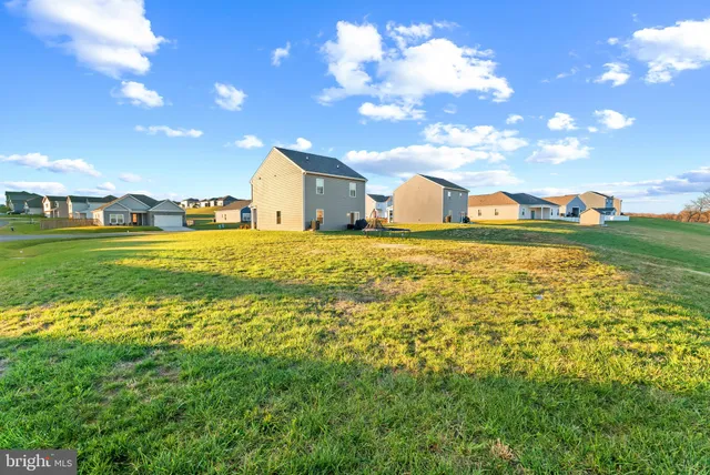 a large yard with lots of green space and a houses