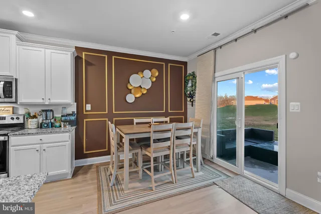 a kitchen with a table and chairs