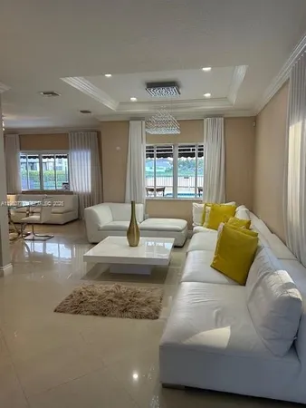 a living room with kitchen and furniture