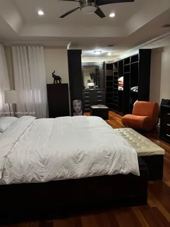 a large bedroom with a large bed and dresser