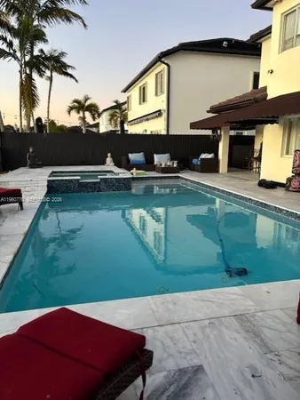 a view of a backyard with table and chairs