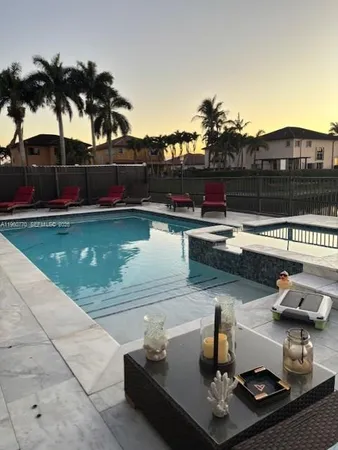 a view of a swimming pool with lounge chair