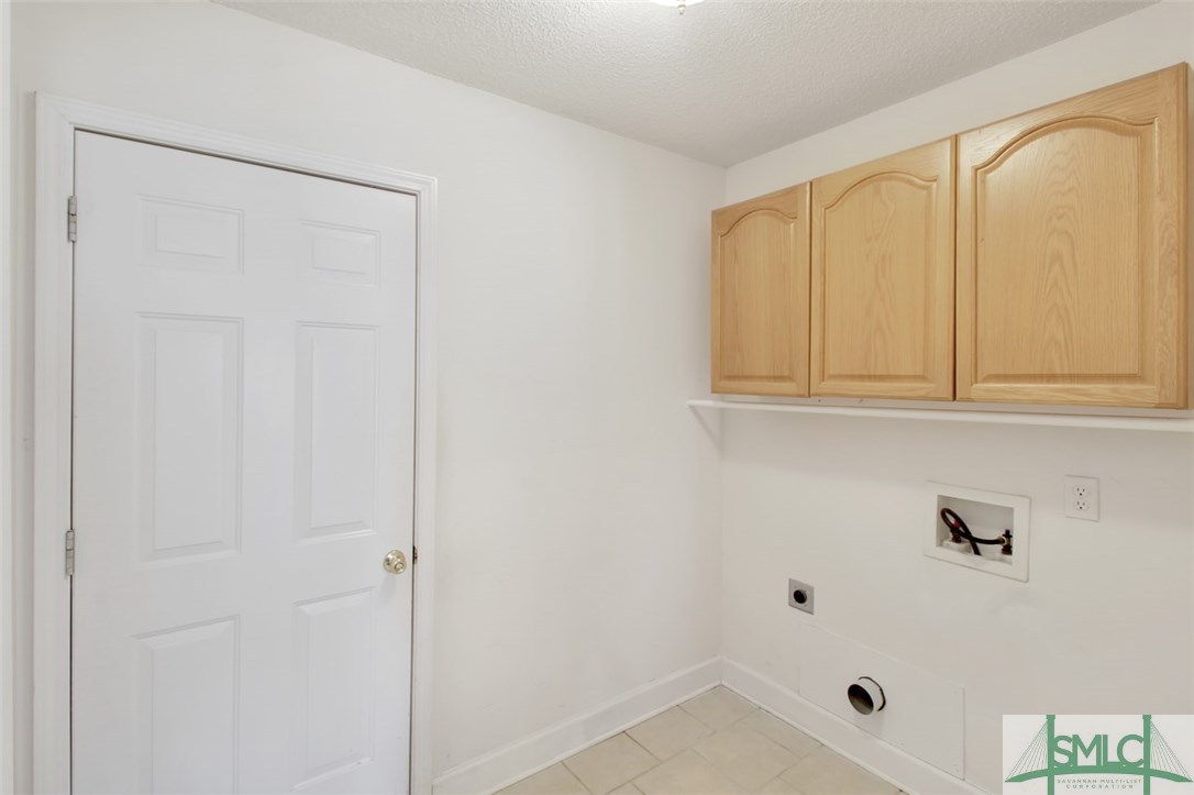 304 Walthour Drive Rincon, GA 31326 - Photo 27 of 40 Laundry room with tile floors and built in cabinet