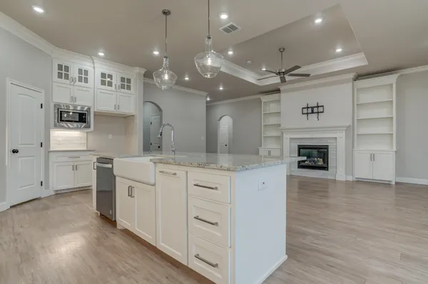 a large kitchen with granite countertop a large window