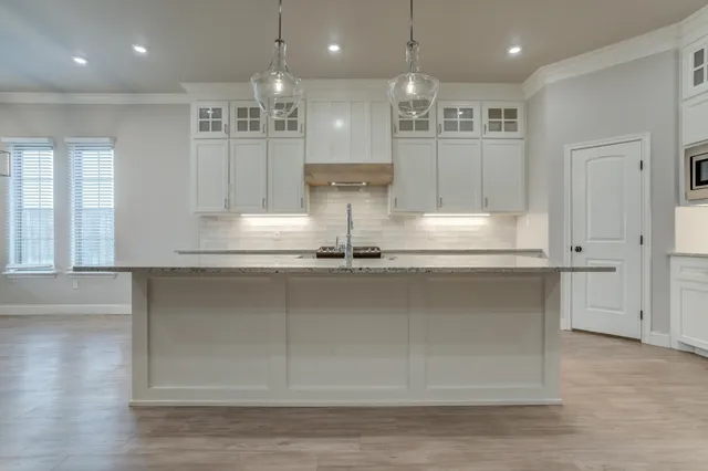 a stove top oven sitting inside of a kitchen