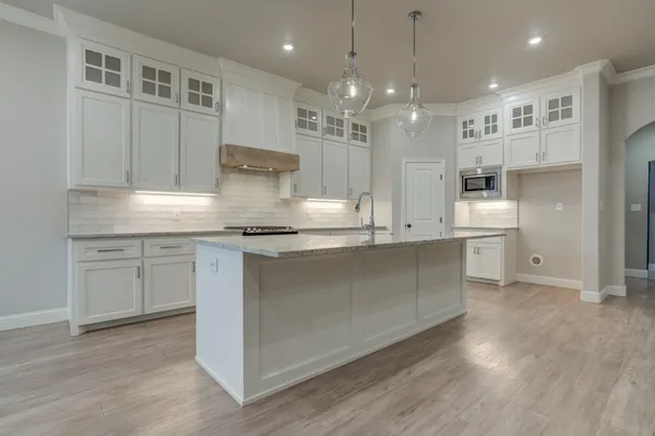 a kitchen with counter top space a sink stainless steel appliances and cabinets