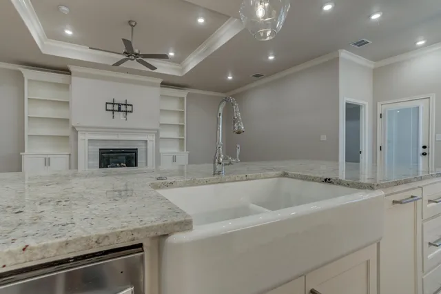 an empty room with windows and ceiling fan