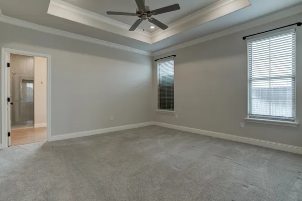 a spacious bathroom with a granite countertop sink mirror and a bathtub