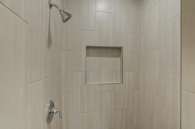 a view of storage and utility room with window