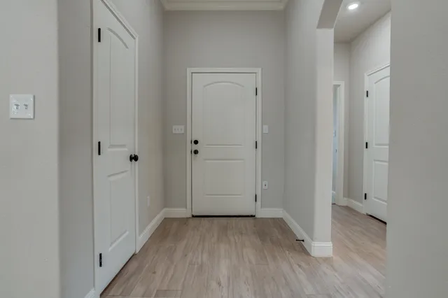 a view of a hallway with wooden floor